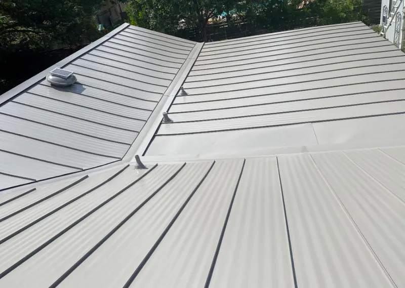 Solar attic fan installed on a metal roof for Roof Ventilation in Island Lake